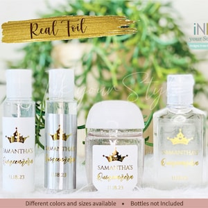 May include: Four clear plastic bottles with gold foil labels. The labels feature a crown design and the text "Samantha's Quinceañera" with the date "11.18.23".