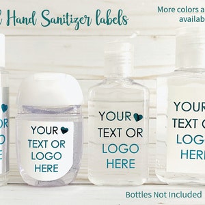May include: Four clear plastic bottles with white lids and labels. The labels are silver, white, and clear with teal text that says "YOUR TEXT OR LOGO HERE" and a teal heart. The bottles are on a white wood surface.