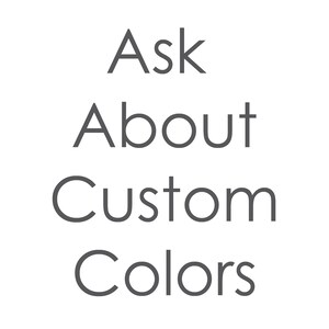 May include: Black background with the words "Ask About Custom Colors" in a light gray, sans-serif font. The text is centered and stacked vertically, with each word on a separate line.