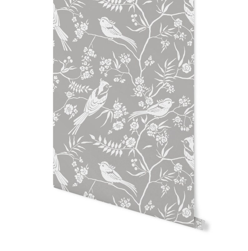 May include: Gray wallpaper with a white floral and bird pattern. The birds are stylized and have long tails. The flowers are small and delicate.