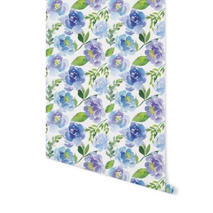 May include: A seamless pattern featuring watercolor blue and purple flowers with green leaves on a white background.