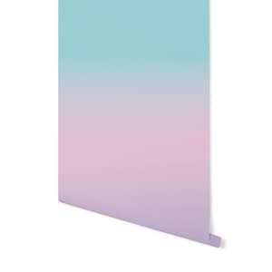 May include: A gradient wallpaper with a light blue to pink color scheme. The wallpaper is rolled up and ready to be hung.