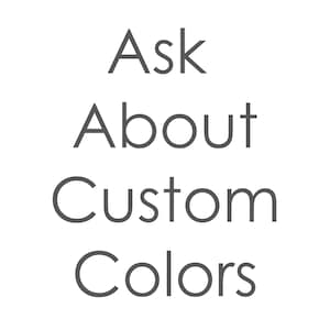 May include: Text that reads "Ask About Custom Colors" in a gray font on a black background.