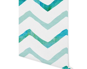 May include: A white background with a repeating pattern of teal and blue watercolor chevron stripes.
