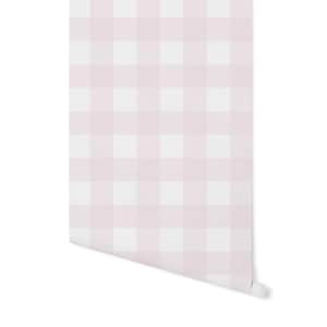 May include: Pink and white gingham wallpaper with a subtle distressed look. The wallpaper is rolled up and ready to be hung.