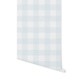 May include: Light blue and white gingham wallpaper with a subtle texture. The wallpaper is rolled up and ready to be hung.