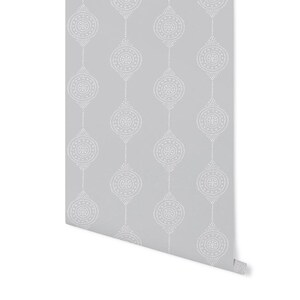 May include: A roll of gray wallpaper with a white repeating pattern of small circles forming a geometric design.