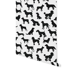 May include: A white background with a repeating pattern of black dog silhouettes. The silhouettes are of different breeds of dogs, including a poodle, a dachshund, a basset hound, and a labrador.