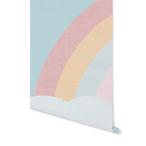 May include: A pastel rainbow wallpaper with a cloud pattern at the bottom. The rainbow is made up of pink, yellow, and blue stripes with a white background.
