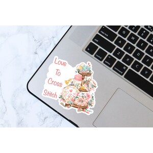 Love to cross stitch sticker on laptop for decoration.