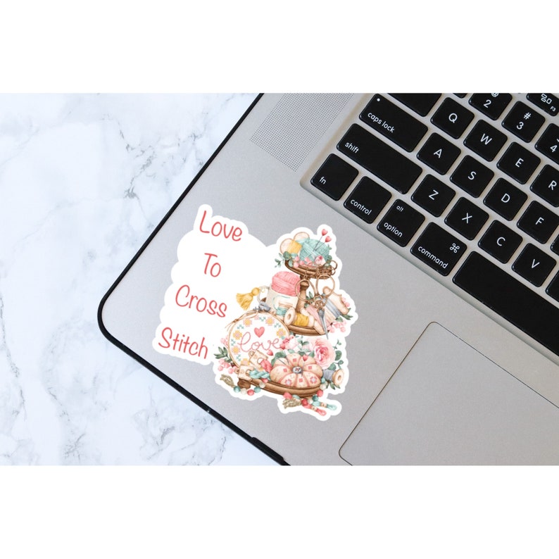 Love to cross stitch sticker on laptop for decoration.