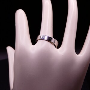 Plain silver stacker ring band.