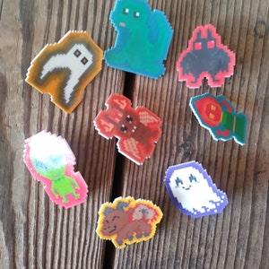 Cryptid Pixel Art Pins - handmade plastic pinback pins feat. Mothman, Bigfoot, Nessie, Yeti, Fresno Nightcrawler pins, more