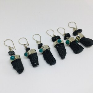 May include: Six pairs of black tourmaline earrings with silver hoops and green gemstone accents.