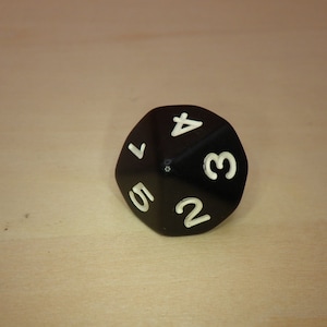 May include: A black 20-sided die with white numbers 1 through 20.