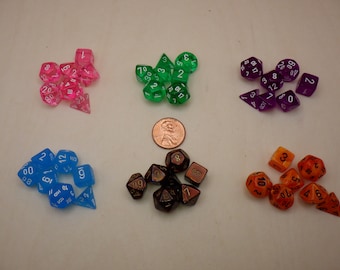 May include: A set of ten dice in various colors, including pink, green, purple, blue, and orange. The dice are made of clear plastic and have white numbers on them.
