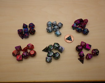 May include: A collection of six sets of polyhedral dice in various colors, including red, blue, green, and black. Each set includes a d4, d6, d8, d10, d%, d12, and d20.