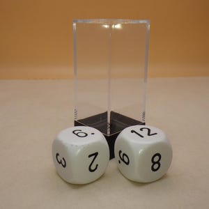May include: Two white dice with black numbers. The dice show the numbers 3, 6, 2, 8, 6, and 12.