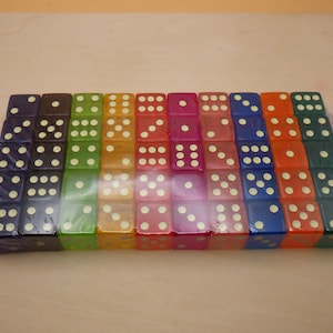 May include: A set of 24 translucent dice in various colors, including purple, green, yellow, orange, red, and blue. The dice have white dots on each side.