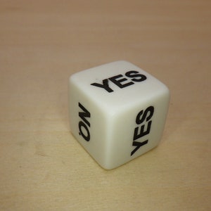 May include: White cube-shaped dice with black lettering. The sides of the dice read "YES" and "NO".