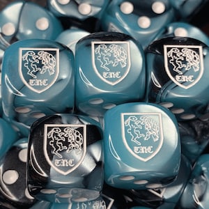 May include: Close-up of teal blue dice with black swirl patterns and white markings. Each die features a white graphic of a rabbit and turtle with the letters "TNC" underneath.