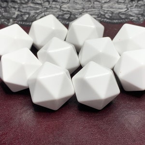 May include: Ten white, opaque, plastic, 12-sided dice. The dice are arranged in a cluster on a dark red surface.