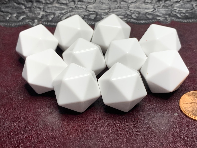 May include: Ten white, opaque, plastic, 12-sided dice. The dice are arranged in a cluster on a dark red surface.