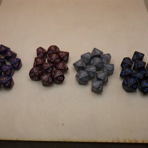 May include: A set of 20 dice in three different colors: purple, maroon, and gray. The dice are speckled with white and have black numbers.