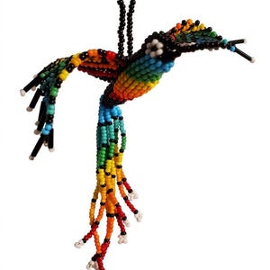 May include: A beaded hummingbird ornament in a vibrant array of colors, including red, orange, yellow, green, blue, and black. The bird's body and wings are meticulously crafted with small beads, and it hangs from a black beaded string.