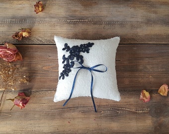 White sequin ring pillow with navy lace applique