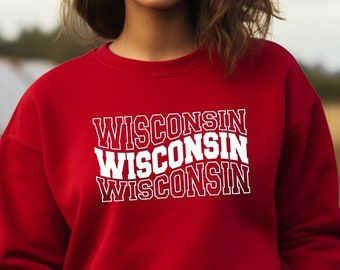 May include: Red sweatshirt with the word "WISCONSIN" repeated three times in white text.