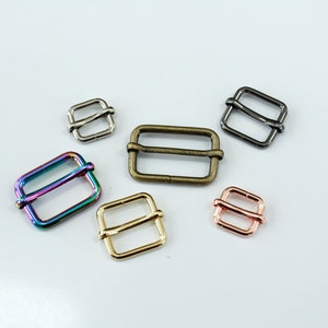 May include: Five different metal slider buckles in various colors, including gold, silver, bronze, rose gold, and iridescent.