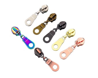 May include: An assortment of zipper pulls in various metallic finishes, including silver, bronze, black, gold, and rose gold. One pull features a vibrant, iridescent rainbow finish. Each pull has a ring for attachment.