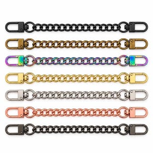 May include: A set of seven metal chain straps, each featuring a lobster clasp at both ends. The chains are available in various finishes including matte black, antique brass, iridescent rainbow, bright gold, polished silver, rose gold, and gunmetal.