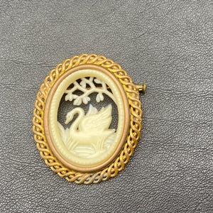 Vintage celluloid swans brooch in a brass frame. Brooch for bird lovers. Bird watcher's gift. Swimming swans brooch.