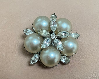 Broche vintage de metal plateado con perlas y cristales blancos.