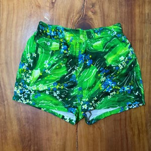 May include: A set of three ceramic mugs with a speckled, matte finish. The mugs are in shades of cream, light gray, and dark gray. Each mug has a simple, minimalist design and a rounded handle.