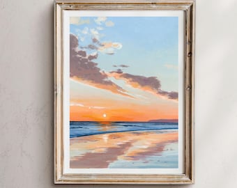 May include: A framed painting of a sunset over a beach. The sky is a mix of blue, pink, and orange, with clouds reflecting in the water. The sun is setting in the distance, casting a warm glow over the scene.