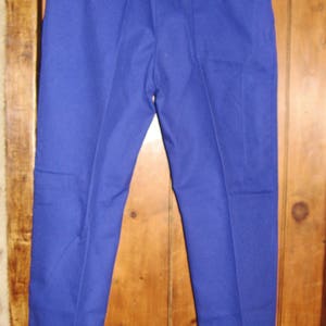May include: A pair of blue pants with a back pocket.