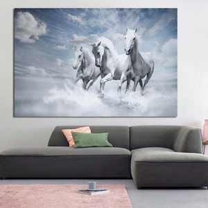 May include: Four white horses run through a misty, cloudy landscape. The horses are in mid-stride, with their manes flowing in the wind. The background is a soft blue with white clouds.