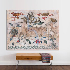 May include: A vintage-style painting of three deer in a forest setting. The deer are depicted in a stylized, almost cartoonish manner, with large eyes and long, slender legs. The painting is done in muted colors, with shades of brown, green, and red. The background is a light beige, with a few clouds and a few stylized flowers.