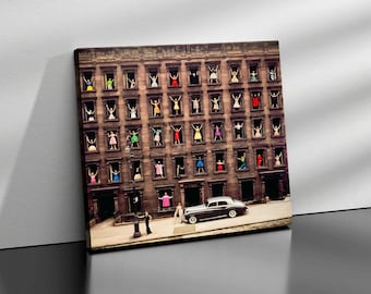 May include: A vintage photograph of a city building with windows, each featuring a woman in a different colored dress. A black car is parked in front of the building.
