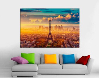 May include: A panoramic view of the Eiffel Tower in Paris, France, with a golden sunset sky and fluffy clouds. The city skyline is visible in the background.