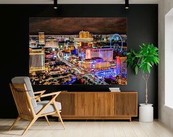 May include: An aerial nighttime view of a city skyline with brightly lit buildings and a Ferris wheel. The city is illuminated with colorful lights, creating a vibrant and dynamic scene.