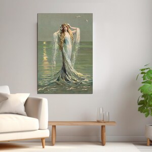 May include: A woman with long blonde hair wearing a flowing white dress stands in the ocean. The water is a light blue and green color, and the sun is setting in the background.