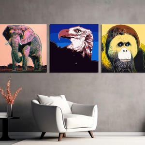 May include: Three colorful pop art style prints featuring a pink elephant, a white bald eagle with a blue background, and a yellow orangutan with a black background.
