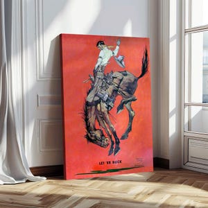 May include: A vintage-style canvas print depicts a cowboy riding a bucking bronco against a red background. The cowboy wears a white shirt, scarf, and hat, with the horse in mid-air. The text "LET 'ER BUCK" is visible at the bottom of the print.