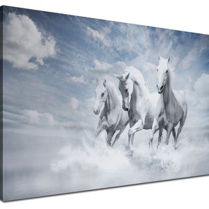May include: Three white horses running through a misty, cloudy landscape. The horses are in mid-stride, with their manes flowing in the wind. The sky is a light blue, with fluffy white clouds.