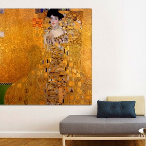 May include: A painting of a woman in a gold dress with a geometric pattern. The background is also gold with a geometric pattern.