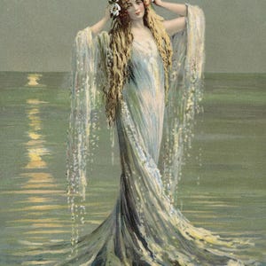 May include: A woman with long blonde hair wearing a white gown with a floral crown stands in the ocean with her arms raised. The water is a light blue-green color and the sky is a light gray. The woman's gown is flowing in the water and her hair is blowing in the wind.